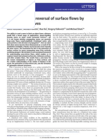 Generation and reversal of surface flows by propagating waves