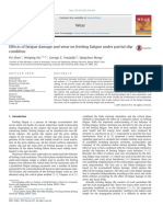 Fatigue damage and wear effects on fretting fatigue under partial slip