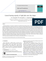 Lateral Bearing Capacity of Rigid Piles Near Clay Slopes: Soils and Foundations